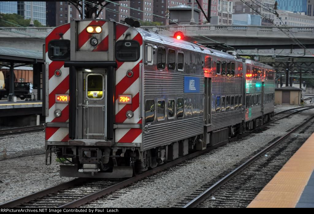 Outbound commuter approaches the station to makes its stop